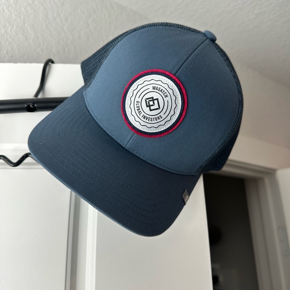 Travis Matthew’s hat Blue Trucker Hat with Logo Patch